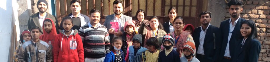Children and volunteers standing together at a child NGO event, promoting education and welfare.